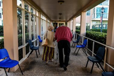 An elderly residents walks inside deserted John Knox Village, a retirement community in Pompano Beach, Florida. AFP  