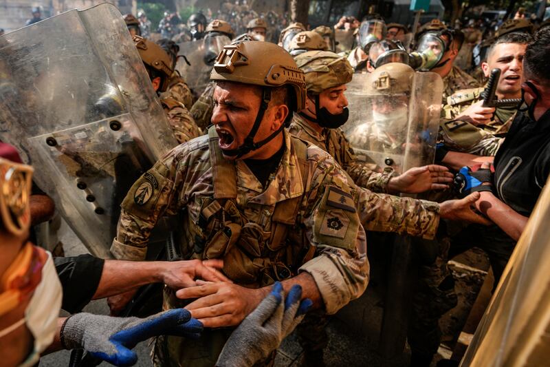 Lebanese Army soldiers scuffle with retired members of the Lebanese security forces and other protesters. AP Photo