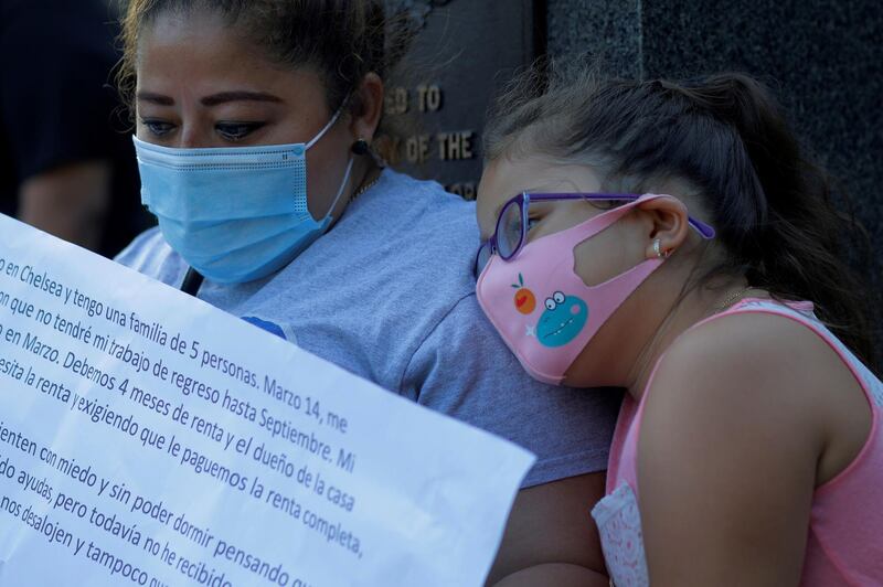 Sandra Cruz sits with her daughter Gabriella after telling her family’s story about losing her job because of the coronavirus  outbreak in the US. Reuters