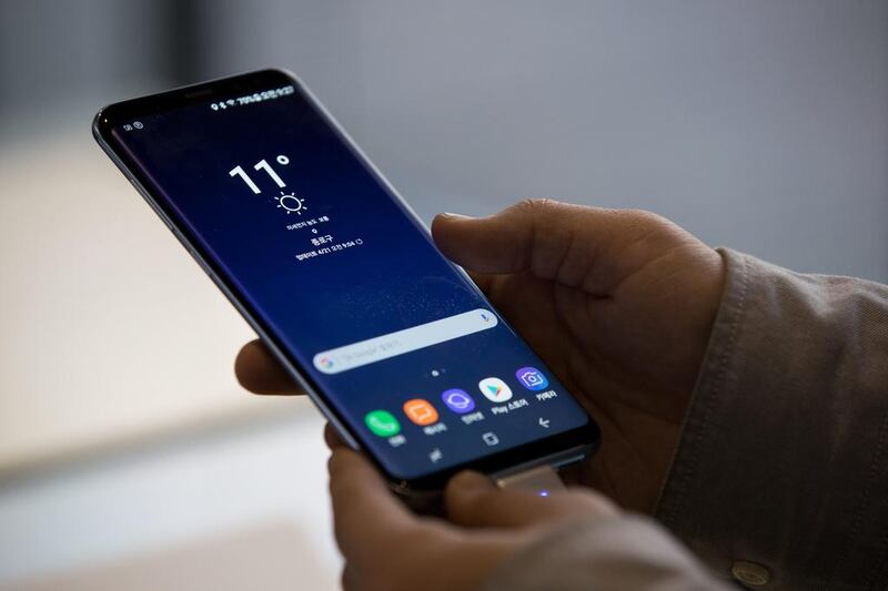 A visitor tries out a Samsung Electronics Galaxy S8 smartphone. SeongJoon Cho / Bloomberg