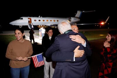 Family members embrace freed Americans. Reuters
