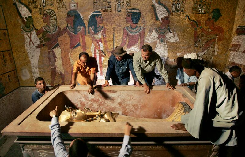 The removal of the mummy of King Tutankhamun in Luxor in 2007. The tomb of his stepmother, Queen Nefertiti, has never been found but is thought to be in a chamber behind. Reuters