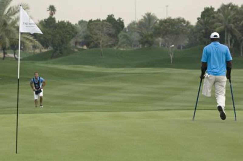 Manuel de los Santos gets around the Emirates Golf Course in Dubai during last month's invitational using his specially-crafted crutches.