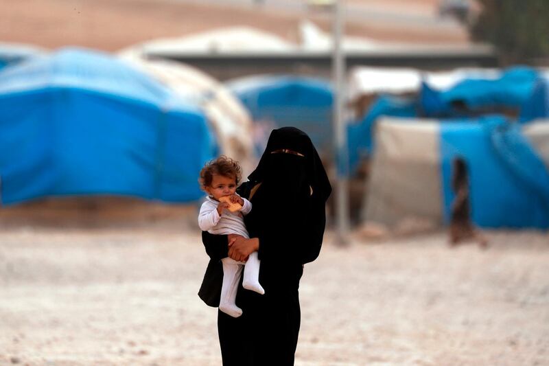 A mother and child walk around at the Ain Issa  refugee camp, north of Raqqa in Syria. Delil Souleiman / AFP