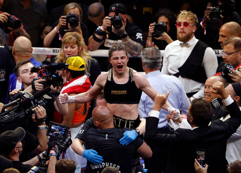 Katie Taylor celebrates after winning by a split decision the undisputed world lightweight championship. EPA