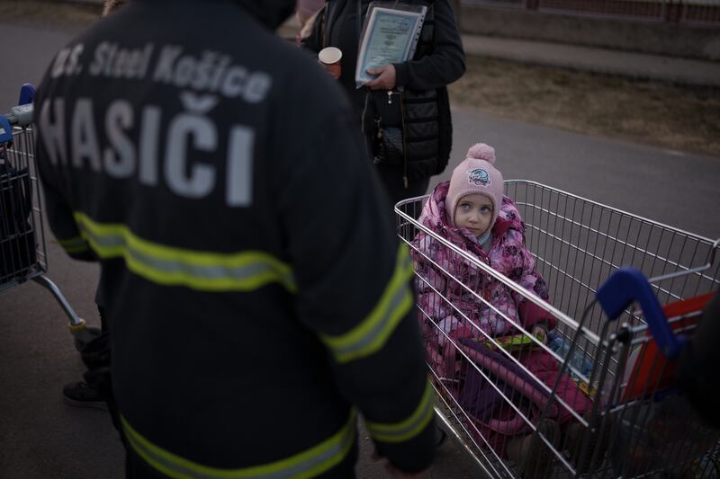 A Ukrainian girl is pushed in a trolley at the Velke Slemence border crossing in Slovakia. Getty