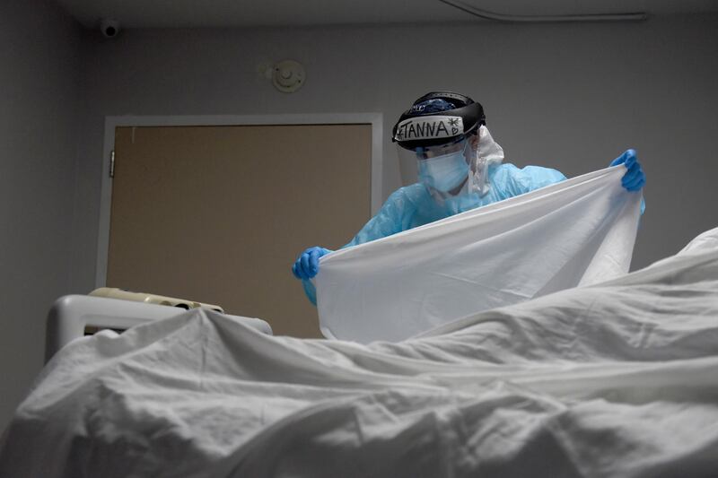 Tanna Ingraham places a sheet over the body of a patient who died inside the coronavirus disease (COVID-19) unit at United Memorial Medical Center in Houston, Texas. Reuters