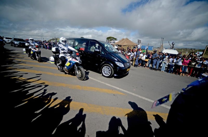 The hearse carrying the coffin of Nelson Mandela drives through the streets of Mthatha on its way to Qunu, where he will be buried on December 15. Filippo Monteforte / AFP