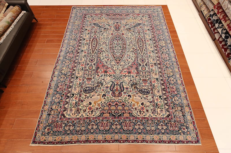 A handmade antique carpet believed to be 130 years old, with four royal peacock designs with central pine tree, made in Tehran. The carpet is priced at $500,000.