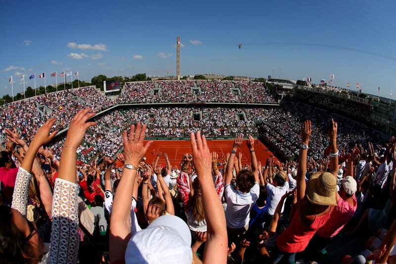 Spectators at Court Philippe Chatrier take part in a mexican wave. Clive Brunskill / Getty Images
