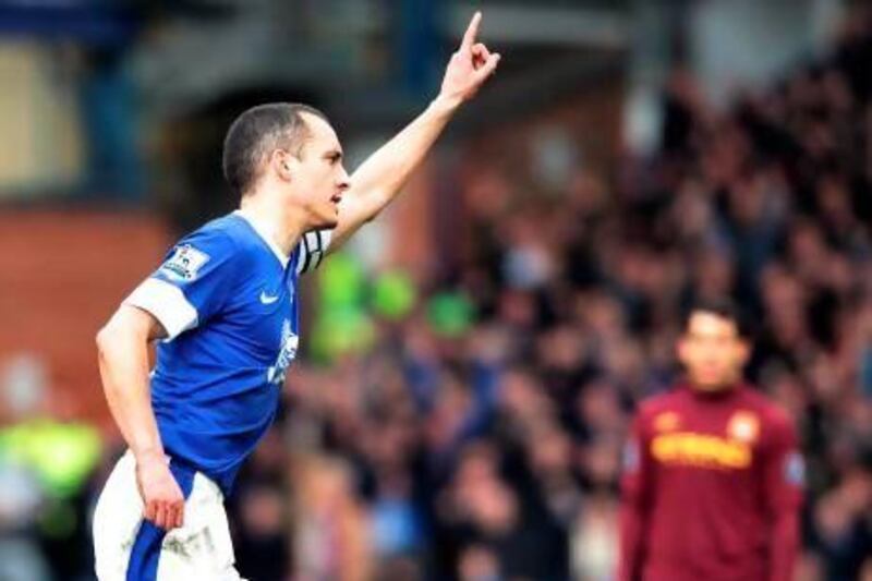 Leon Osman, left, capped a memorable week personally by scoring a stunning goal against Manchester City at Goodison Park. Lindsey Parnaby / AFP