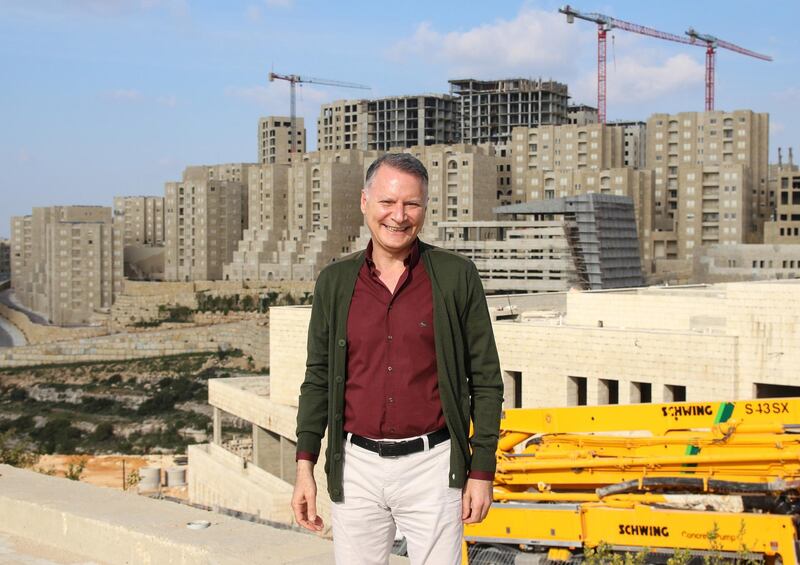 The Palestinian-American investor Baschar Masri stands in front of his largest project, at the construction site of the Palestinian planned city Rawabi, Palestine, 22 March 2016. Rawabi is the largest construction project in the history of the Palestinian territories. For five years the city has been being built upon the hill. Photo by: David Ehl/picture-alliance/dpa/AP Images