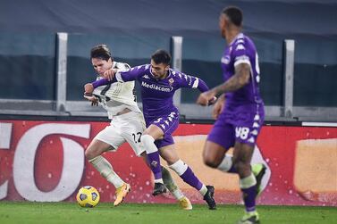 Juventus' Federico Chiesa, left, competes for the ball during the Serie A soccer match between Juventus and Fiorentina, at the Allianz Stadium in Turin, Italy, Tuesday, December 22, 2020. AP