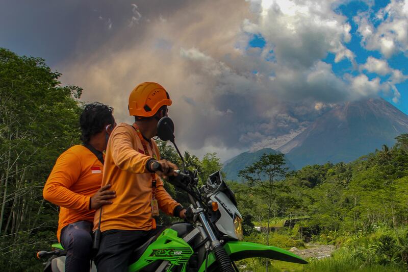 People watch as Mount Merapi erupts. AP 