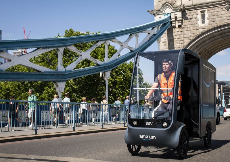 An Amazon employee delivers parcels using a new e-cargo bike in London. PA