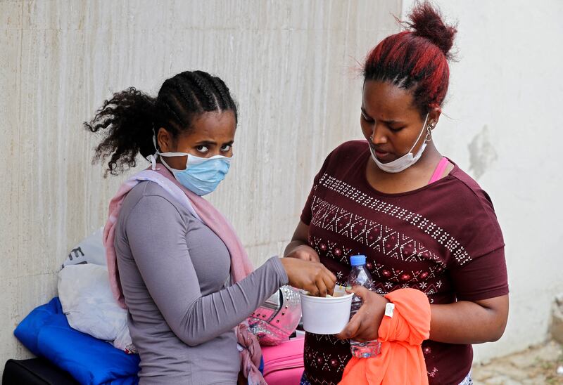 Ethiopian domestic workers who were dismissed by their employers gather with their belongings outside their country's embassy in Hazmiyeh, east of Beirut. AFP