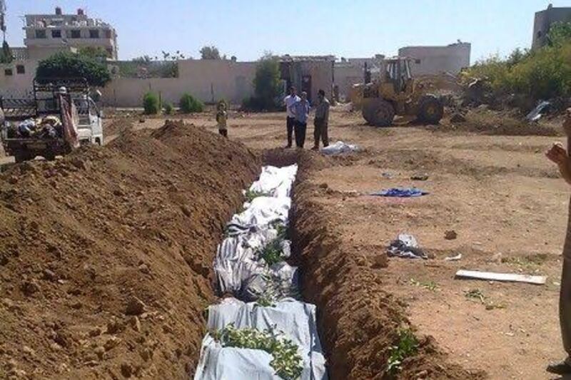Some of the hundreds of civilian men, women and children who died in a bloody door-to-door killing spree by government forces were buried in this mass grave in Daraya.