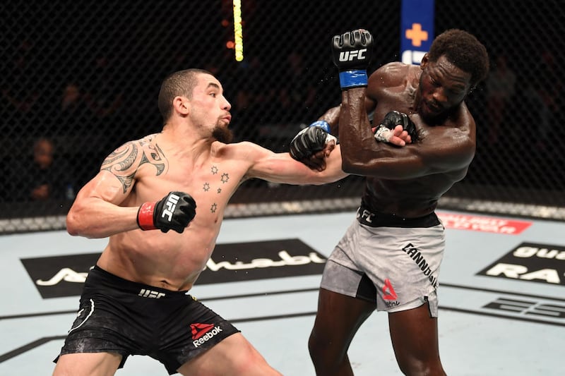 ABU DHABI, UNITED ARAB EMIRATES - OCTOBER 25:  (L-R) Robert Whittaker of Australia punches Jared Cannonier in their middleweight bout during the UFC 254 event on October 25, 2020 on UFC Fight Island, Abu Dhabi, United Arab Emirates. (Photo by Josh Hedges/Zuffa LLC via Getty Images)