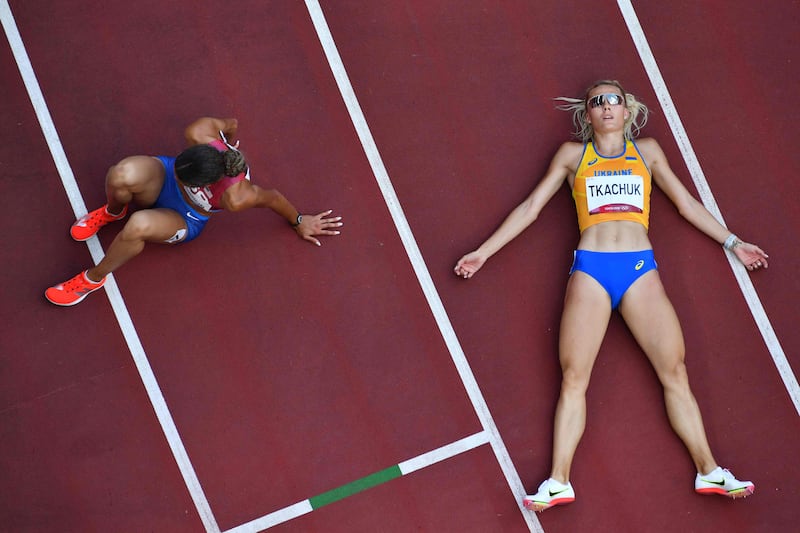 Ukraine's Viktoriya Tkachuk, right, and USA's Sydney Mclaughlin react after competing in the women's 400m hurdles final during the Tokyo 2020 Olympic Game.