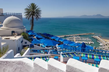 Terrace with a view of the port, Sidi Bou Saïd, Tunisia. A slump in tourism, which accounts for 13.9% of GDP for Tunisia and an important source of employment, is also set to weigh down the wider economy. Getty Images