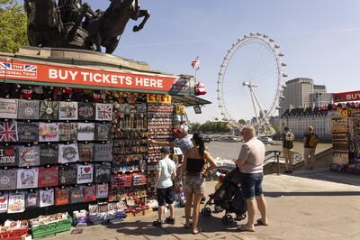 Tourists examine stock at a souvenir stall in London, U.K., on Monday, June 14, 2021. U.K. Prime Minister Boris Johnson is preparing to delay his plan to lift England's pandemic restrictions amid concerns that a rapid rise in Covid-19 cases could put hospitals under strain. Photographer: Jason Alden/Bloomberg