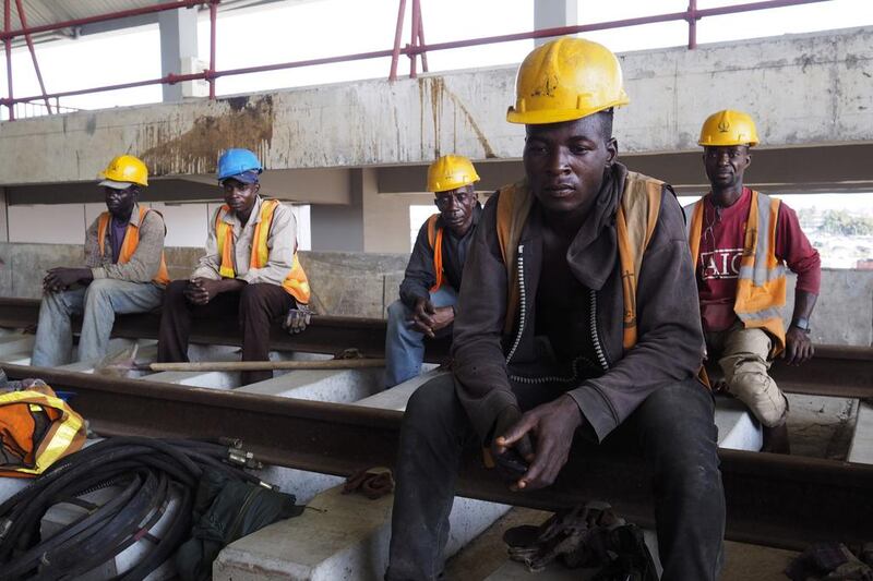 Men take a break from work at the National Arts Theatre stop of the light rail system under construction in Lagos, Nigeria. Joe Penney / Reuters