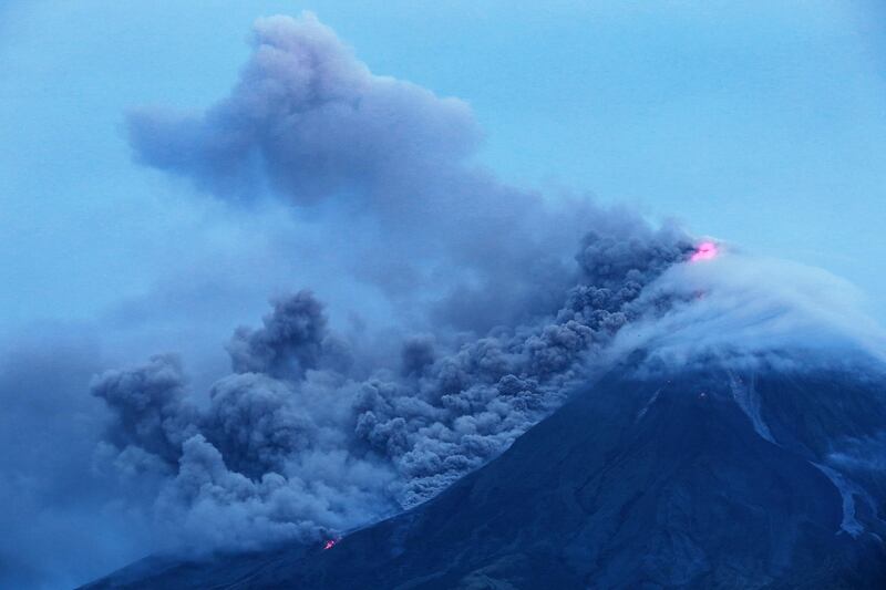 Cloud-covered Mayon volcano spews ash as it erupts near the Philippine city of Legazpi in Albay province. Charism Sayat / AFP Photo
