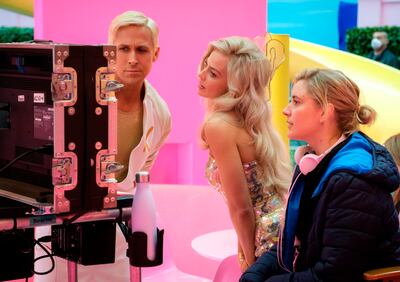 Ryan Gosling, left, Margot Robbie, centre, with director Greta Gerwig on the set of Barbie. AP