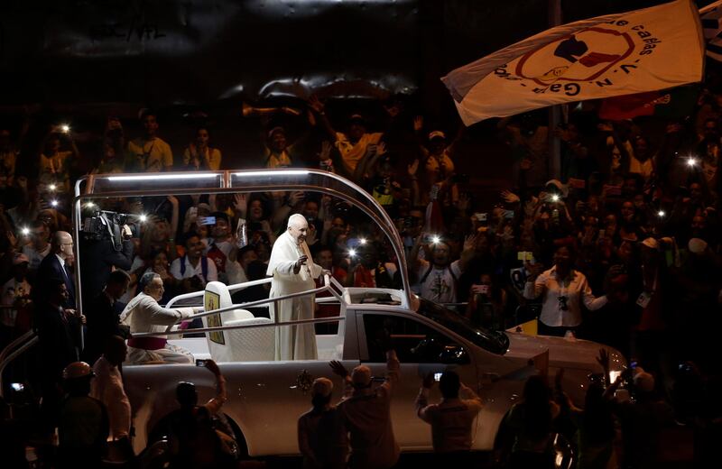 Pope Francis waves to the crowd as he rides his popemobile in Panama City. AP Photo