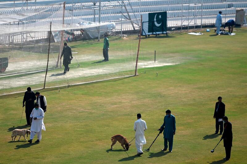 Security personnel and sniffer dogs inspect the Rawalpindi Cricket Stadium. AFP