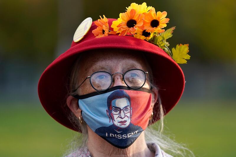 A woman listens to speakers outside of Revolution Hall before marching in Portland, Oregon. AP Photo