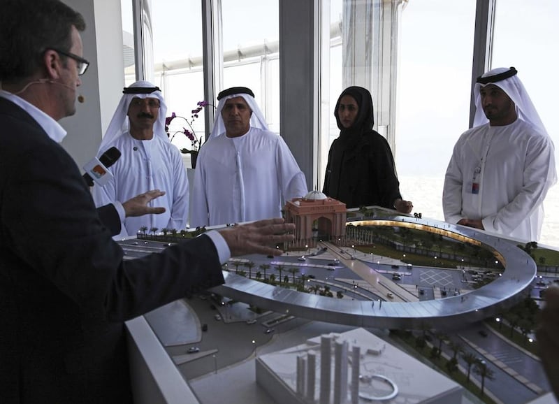 Rob Lloyd, chief executive of Hyperloop One, left, shows a model of the transport system to Mattar Al Tayer, director general of the RTA, in Dubai. AP Photo