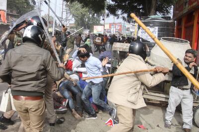 In this photo taken on December 19, 2019 police beat protesters with sticks during a demonstration against India's new citizenship law in Lucknow. Indians defied bans on assembly on December 19 in cities nationwide as anger swells against a citizenship law seen as discriminatory against Muslims, following days of protests, clashes and riots that have left six dead.
 / AFP / STR
