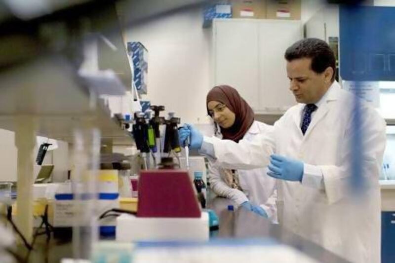 UAE University associate professor of molecular and genetic medicine Dr Bassam Ali, with one of the students working on the research project into birth defects. The programme has received a grant of Dh333,000 to continue its work for another two years.  Christopher Pike / The National