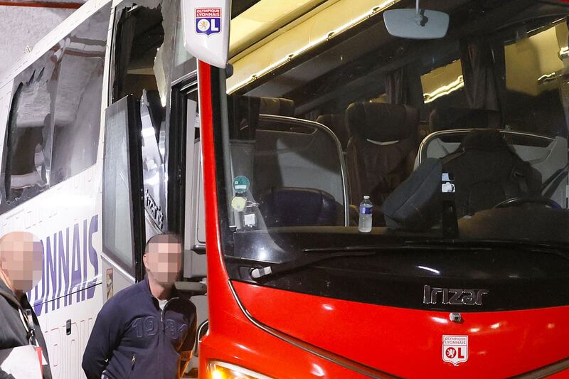 Lyon's team bus with one window completely broken and another damaged after the bus was stoned as it entered the Stade Velodrome. AFP
