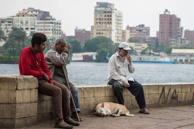 People sit on the bank of River Nile during a cloudy morning in Cairo, Egypt. EPA