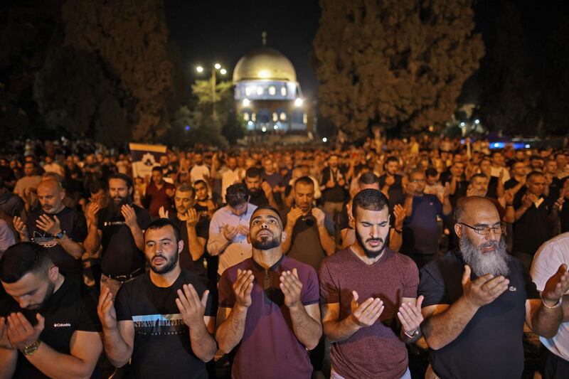 Palestinian devotees pray in pursuit of Laylat Al Qadr outside the Dome of the Rock in Jerusalem's Al Aqsa Mosque compound during the last 10 days of Ramadan. AFP