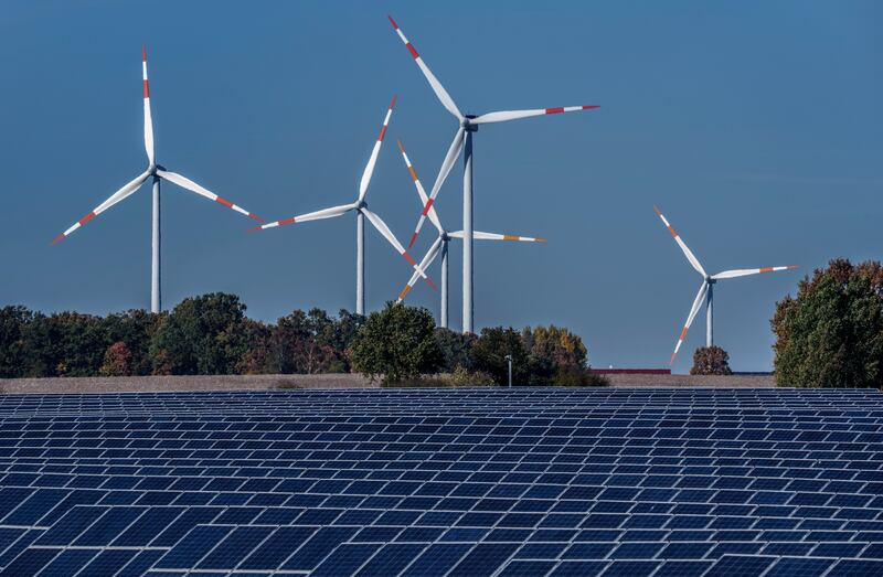 Wind turbines turn behind a solar farm in Rapshagen, about 136km north-west of Berlin. AP