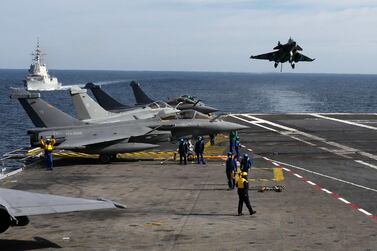 A Rafale fighter jet lands on France's Charles de Gaulle aircraft carrier in February 2019. AFP