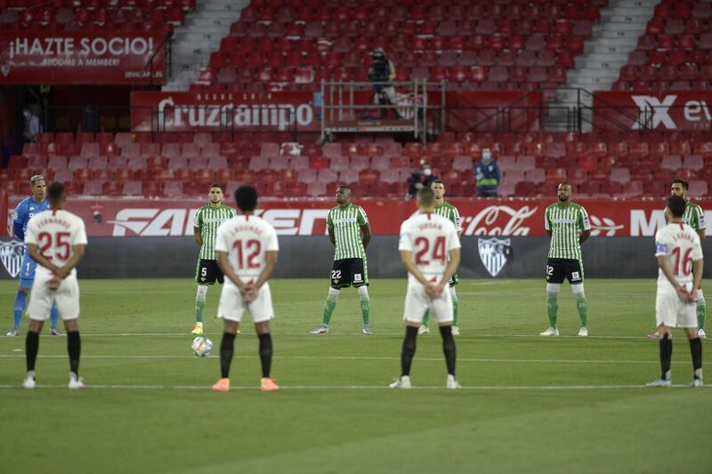 Players hold a minute of silence for coronavirus victims before the match. AFP