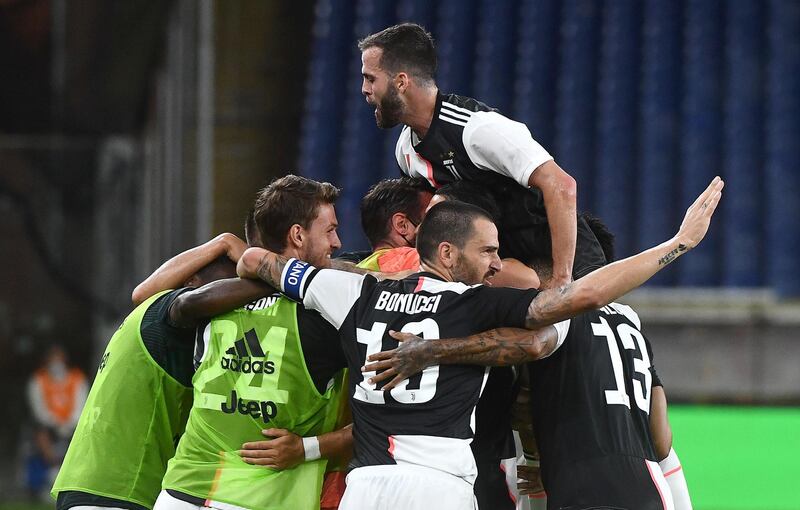 Juventus players celebrate with Cristiano Ronaldo after he scored the second goal. EPA