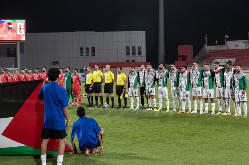 The Palestine and Lebanon players line up before kick-off. Antonie Robertson/The National