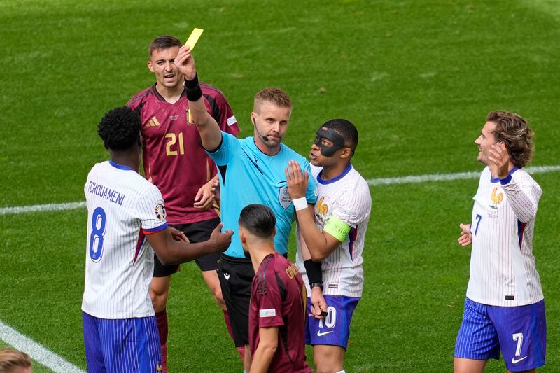 Kylian Mbappe of France pleads with the referee as Aurelien Tchouameni of France is shown the yellow card. AP 