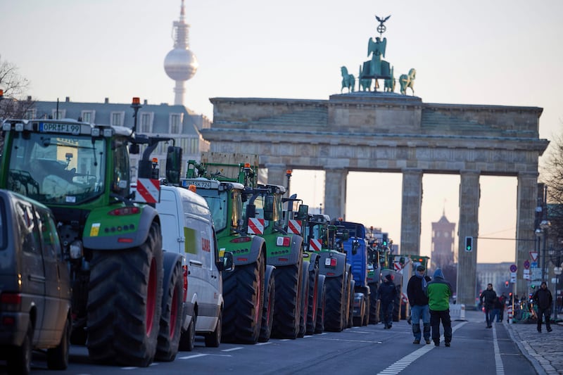 Tractors block the western road to Berlin's Brandenburg Gate on Monday at the start of a week-long protest against tax rises affecting farmers. AP