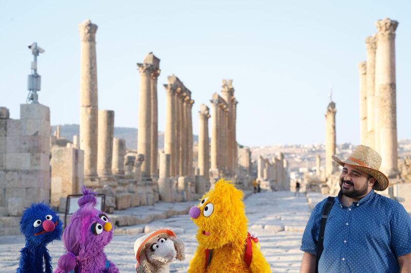 This image released by Sesame Workshop shows, from left, Grover, Basma, Ma'zooza and Jad with Rami Delshad, who portrays Hadi in "Welcome Sesame," a new, locally produced Arabic TV program  for the hundreds of thousands of children dealing with displacement in Syria, Iraq, Jordan and Lebanon.  (Sesame Workshop via AP)