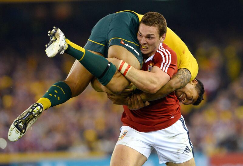 TOPSHOTSBritish and Irish Lions winger George North (R) carries Australian Wallabies winger Israel Folau on his shoulder as he runs forward with the ball in the second rugby Test match, in Melbourne on June 29, 2013.    AFP PHOTO/William WEST  IMAGE RESTRICTED TO EDITORIAL USE - STRICTLY NO COMMERCIAL USE
 *** Local Caption ***  454279-01-08.jpg