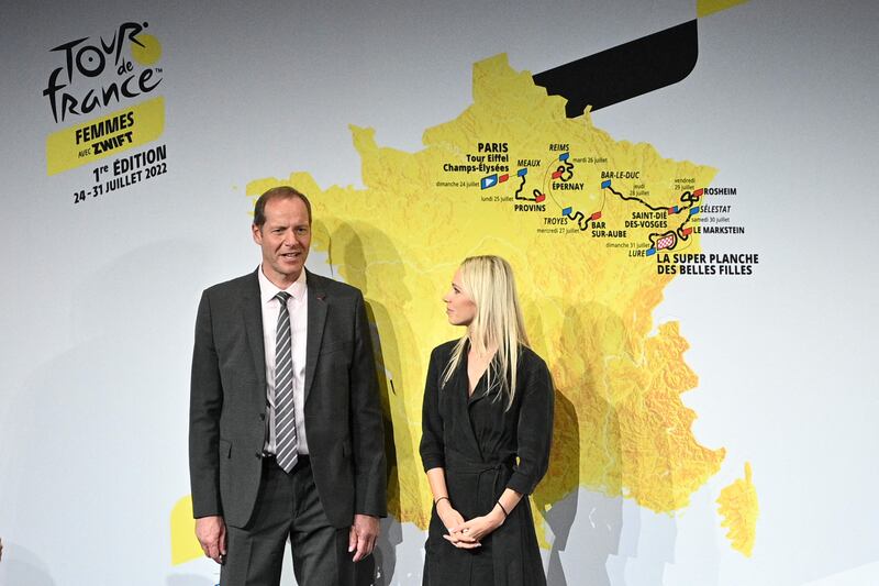 Tour de France director Christian Prudhomme and French cyclist Marion Rousse pose next to the map displaying the route of the women's Tour de France. AFP