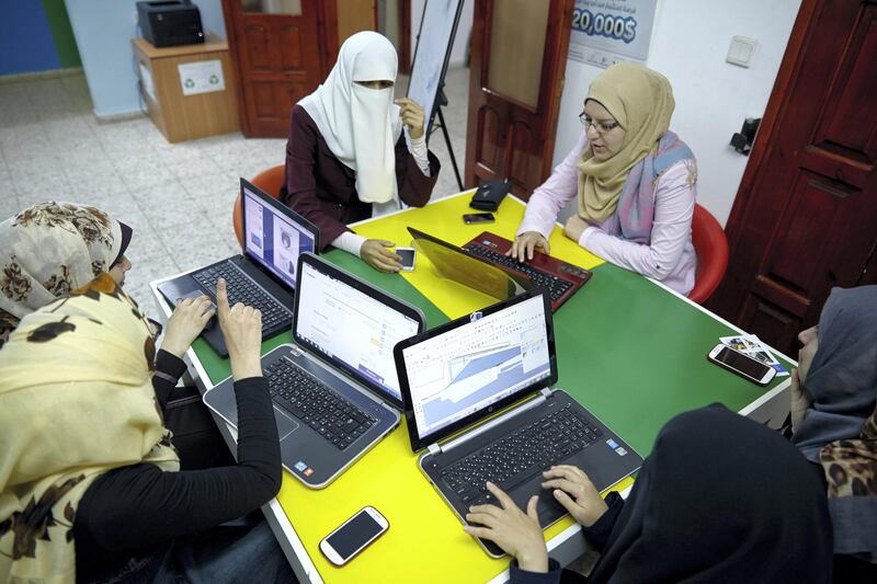 Female tech freelancers work on laptop computers at the offices of Gaza Sky Geeks in Gaza City, Palestinian Occupied Territories, on Thursday, June 25, 2015. Gaza Sky Geeks is a startup "accelerator" backed by Google Inc. and U.S. charity MercyCorps that nurtures business ideas and connects entrepreneurs with investors. Photographer: Shawn Baldwin/Bloomberg