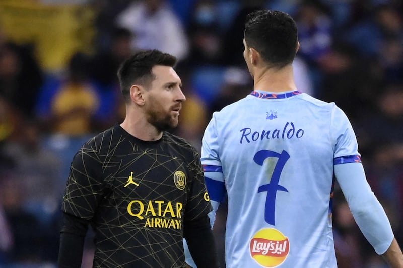 Lionel Messi walks past Cristiano Ronaldo during a football friendly in Riyadh in January. AFP