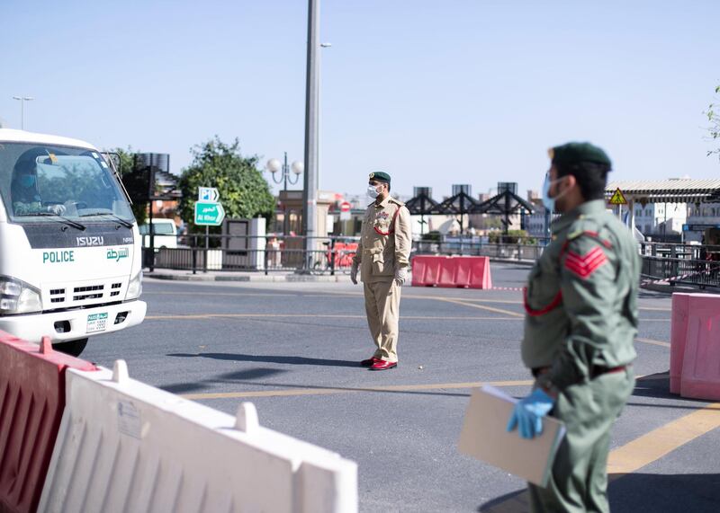 DUBAI, UNITED ARAB EMIRATES. 31 MARCH 2020. 
Dubai Police open the barricade to allow a police car to enter Al Ras.
 Dubai’s Supreme Committee of Crisis and Disaster Management announced increased restrictions on movement in Al Ras area of Dubai for two weeks effective from today to facilitate intensified sterilisation procedures. 

@DubaiPoliceHQ
 appeals to the public to cooperate fully with the authorities and abide by all instructions to ensure the preventive measures implemented during the two-week period are a success. People who are not residents of Al Ras are prohibited from travelling to the area.

RTA closed entrances leading to Al Ras area from three main roads and interchanges: Al Musalla, Al Khaleej, and Baniyas Streets. The plan also includes the closure of three stations on the metro green line: Al Ras, Palm Deira and Baniyas Square.

(Photo: Reem Mohammed/The National)

Reporter: NICK WEBSTER
Section: COVID NA 